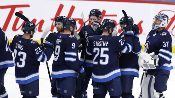May 11, 2021; Winnipeg, Manitoba, CAN; Winnipeg Jets players celebrate on the ice after defeating the Vancouver Canucks at Bell MTS Place. Mandatory Credit: James Carey Lauder-USA TODAY Sports