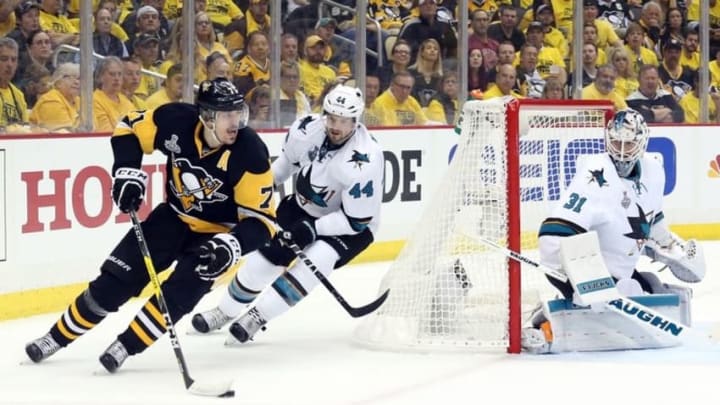 Jun 1, 2016; Pittsburgh, PA, USA; Pittsburgh Penguins center Evgeni Malkin (71) controls the puck behind the net of San Jose Sharks defenseman Marc-Edouard Vlasic (44) and goalie Martin Jones (31) in the second period of game two of the 2016 Stanley Cup Final at Consol Energy Center. Mandatory Credit: Charles LeClaire-USA TODAY Sports