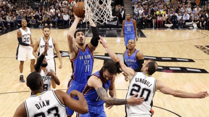 May 10, 2016; San Antonio, TX, USA; Oklahoma City Thunder center Enes Kanter (11) shoots the ball as San Antonio Spurs shooting guard Manu Ginobili (20) defends in game five of the second round of the NBA Playoffs at AT&T Center. Mandatory Credit: Soobum Im-USA TODAY Sports