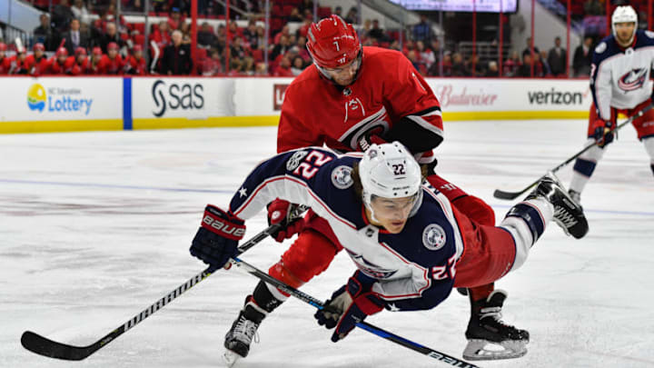RALEIGH, NC - OCTOBER 10: Columbus Blue Jackets Right Wing Sonny Milano (22) trips over the knee of Carolina Hurricanes Center Derek Ryan (7) while skating with the puck in a game between the Columbus Blue Jackets and the Carolina Hurricanes at the PNC Arena in Raleigh, NC on October 10, 2017. Columbus defeated Carolina 2 - 1 in overtime. (Photo by Greg Thompson/Icon Sportswire via Getty Images)