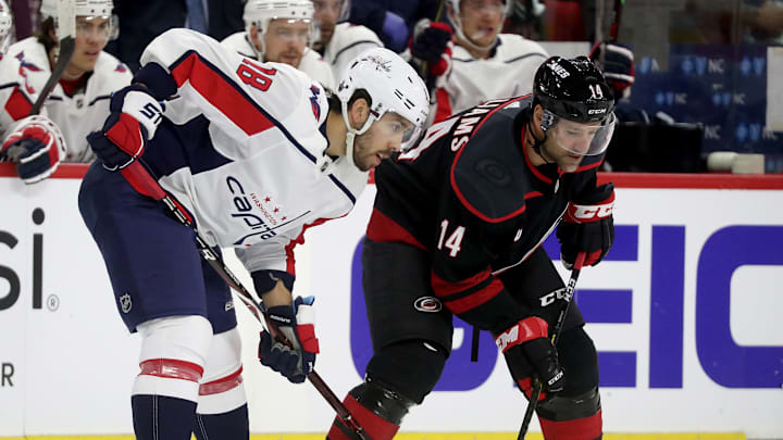 RALEIGH, NC – APRIL 15: Chandler Stephenson #18 of the Washington Capitals and Justin Williams #14 of the Carolina Hurricanes battle for position prior to the face-off in Game Three of the Eastern Conference First Round during the 2019 NHL Stanley Cup Playoffs on April 15, 2019 at PNC Arena in Raleigh, North Carolina. (Photo by Gregg Forwerck/NHLI via Getty Images)