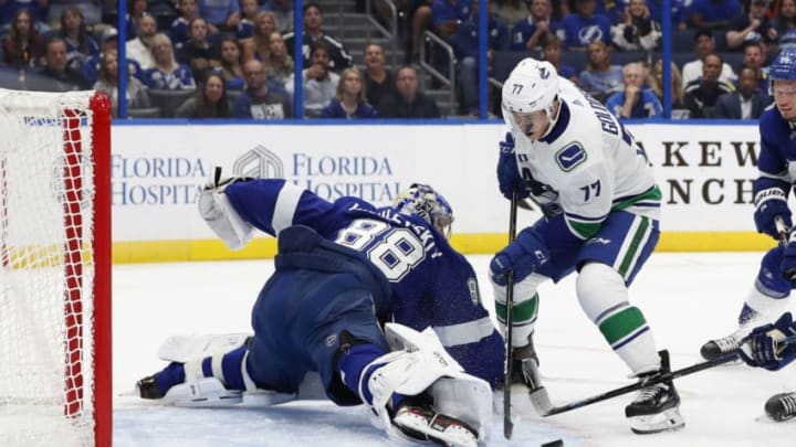 TAMPA, FL - OCTOBER 11: Tampa Bay Lightning goaltender Andrei Vasilevskiy (88) makes a save on a shot from Vancouver Canucks right wing Nikolay Goldobin (77) during the regular season NHL game between the Vancouver Canucks and Tampa Bay Lightning on October 11, 2018 at Amalie Arena in Tampa, FL. (Photo by Mark LoMoglio/Icon Sportswire via Getty Images)