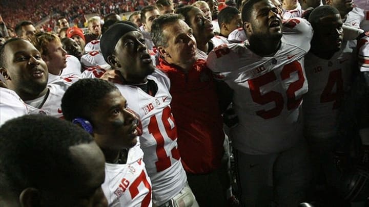 Nov 17, 2012; Madison, WI, USA; Ohio State Buckeyes players and head coach Urban Meyer sing their school song “carmen ohio” after their overtime victory over the Wisconsin Badgers at Camp Randall Stadium. Ohio State defeated Wisconsin 21-14. Mandatory Credit: Mary Langenfeld-USA TODAY Sports