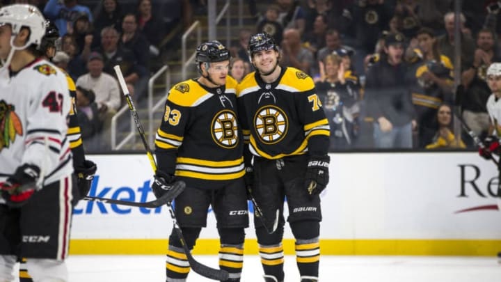 BOSTON - SEPTEMBER 28: Boston Bruins center Karson Kuhlman (83) and Boston Bruins left wing Jake DeBrusk (74) celebrate after their sixth goal. The Boston Bruins host the Chicago Blackhawks in their final pre-season NHL hockey game at TD Garden in Boston on Sep. 28, 2019. (Photo by Nic Antaya for The Boston Globe via Getty Images)