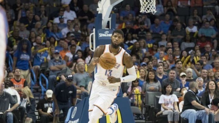 OKLAHOMA CITY, OK - OCTOBER 8: Paul George #13 of the Oklahoma City Thunder brings the ball down court against Melbourne United during the first half of a NBA preseason game at the Chesapeake Energy Arena on October 8, 2017 in Oklahoma City, Oklahoma. NOTE TO USER: User expressly acknowledges and agrees that, by downloading and or using this photograph, User is consenting to the terms and conditions of the Getty Images License Agreement. (Photo by J Pat Carter/Getty Images)