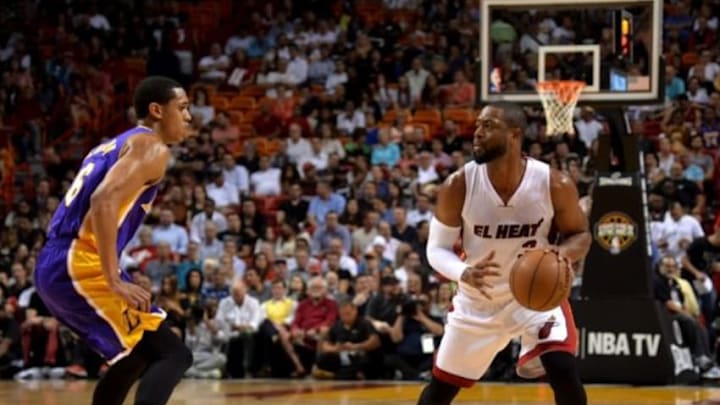 Mar 4, 2015; Miami, FL, USA; Miami Heat guard Dwyane Wade (3) dribbles the ball against Los Angeles Lakers guard Jordan Clarkson (6) during the first half at American Airlines Arena. Mandatory Credit: Steve Mitchell-USA TODAY Sports