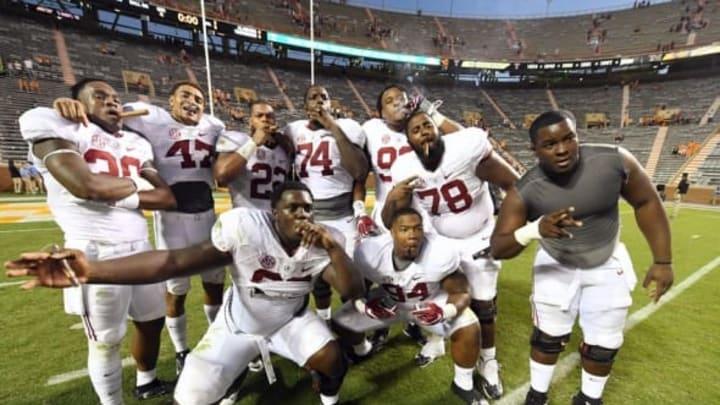 Oct 15, 2016; Knoxville, TN, USA; Alabama Crimson Tide players celebrate their 49-10 victory with a traditional victory cigar after defeating the Tennessee Volunteers at Neyland Stadium. Mandatory Credit: John David Mercer-USA TODAY Sports