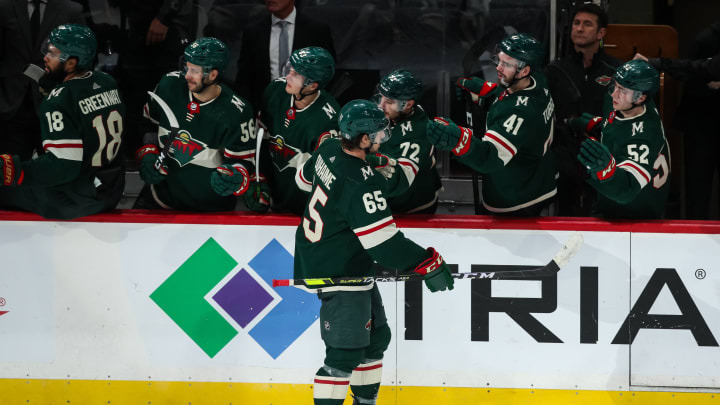 Oct 6, 2021; Saint Paul, Minnesota, USA; Minnesota Wild right wing Brandon Duhaime (65) celebrates with teammates after scoring a goal against the St. Louis Blues in the third period at Xcel Energy Center. Mandatory Credit: David Berding-USA TODAY Sports