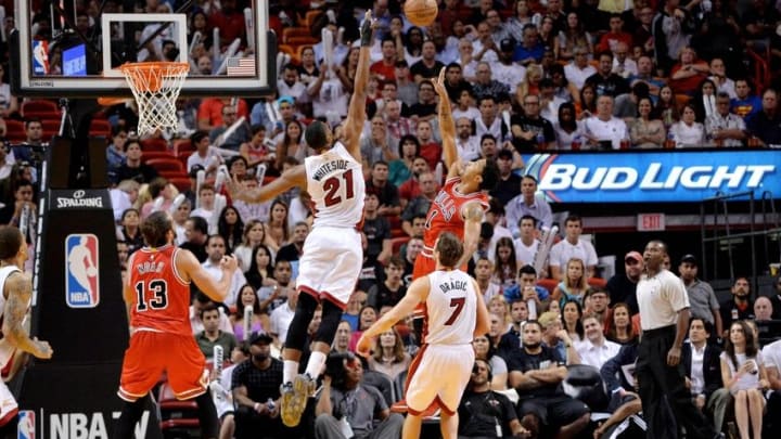 Apr 9, 2015; Miami, FL, USA; Chicago Bulls guard Derrick Rose (1) shoots over Miami Heat center Hassan Whiteside (21) during the second half at American Airlines Arena. Mandatory Credit: Steve Mitchell-USA TODAY Sports
