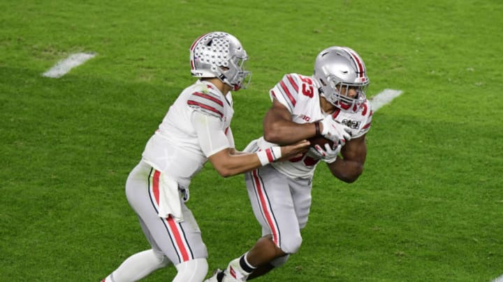 Jan 11, 2021; Miami Gardens, FL, USA; Ohio State Buckeyes quarterback Justin Fields (1) hands off to running back Master Teague III (33) against the Alabama Crimson Tide in the second quarter in the 2021 College Football Playoff National Championship Game at Hard Rock Stadium. Mandatory Credit: Douglas DeFelice-USA TODAY Sports