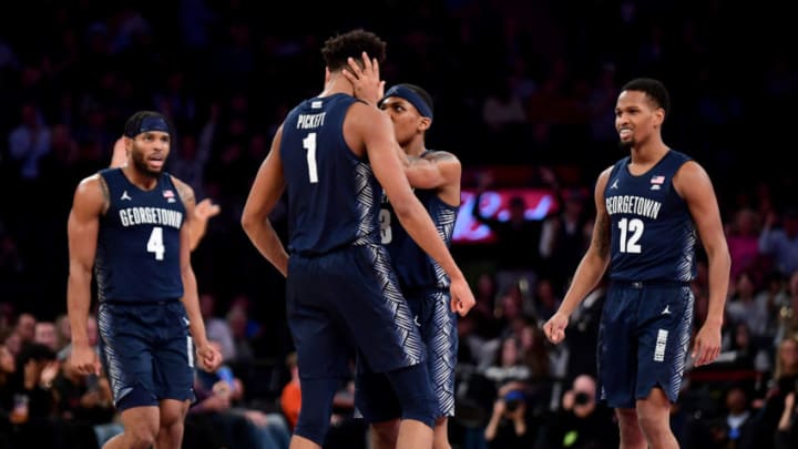 NEW YORK, NEW YORK - NOVEMBER 21: James Akinjo #3 celebrates with Jamorko Pickett #1 of the Georgetown Hoyas after his basket in the second half of their game against the Texas Longhorns at Madison Square Garden on November 21, 2019 in New York City. (Photo by Emilee Chinn/Getty Images)