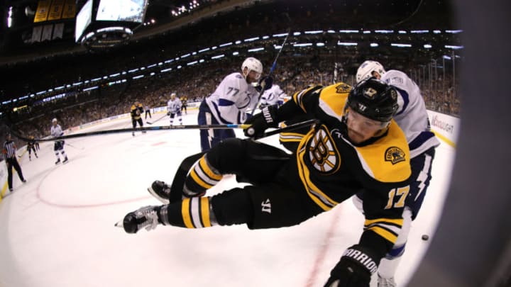 BOSTON, MA - MAY 4: Cedric Paquette #13 of the Tampa Bay Lightning checks Ryan Donato #17 of the Boston Bruins into the boards during the third period of Game Four of the Eastern Conference Second Round during the 2018 NHL Stanley Cup Playoffs at TD Garden on May 4, 2018 in Boston, Massachusetts.(Photo by Maddie Meyer/Getty Images)
