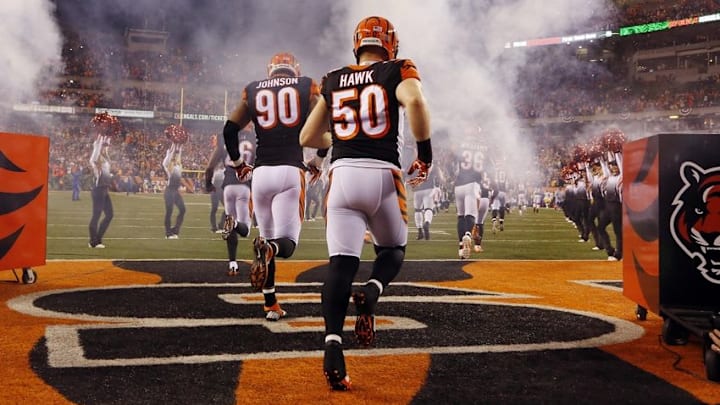 Jan 9, 2016; Cincinnati, OH, USA; Cincinnati Bengals outside linebacker A.J. Hawk (50) and defensive end Michael Johnson (90) run onto the field before the AFC Wild Card playoff football game against the Pittsburgh Steelers at Paul Brown Stadium. Mandatory Credit: David Kohl-USA TODAY Sports