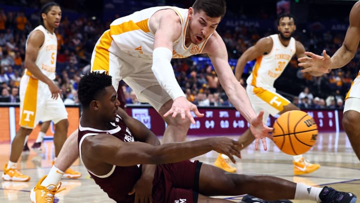 Mar 13, 2022; Tampa, FL, USA; Texas A&M Aggies forward Henry Coleman III (on floor) and Tennessee Volunteers forward John Fulkerson (10) battle for a loose ball during the first half at Amalie Arena. Mandatory Credit: Kim Klement-USA TODAY Sports