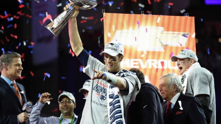 Feb 1, 2015; Glendale, AZ, USA; New England Patriots quarterback Tom Brady (12) celebrates with the Vince Lombardi Trophy after Super Bowl XLIX against the Seattle Seahawks at University of Phoenix Stadium. The Patriots defeated the Seahawks 28-24. Mandatory Credit: Kyle Terada-USA TODAY Sports