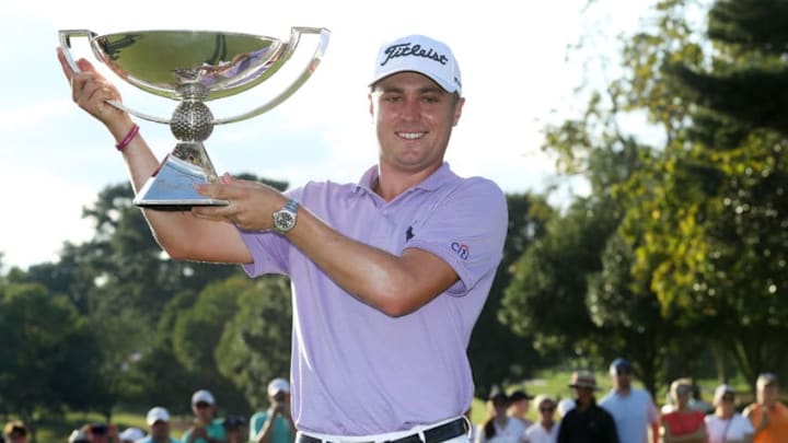 ATLANTA, GA - SEPTEMBER 24: Justin Thomas of the United States celebrates with the trophy on the 18th green after winning the FedExCup and second in the TOUR Championship during the final round at East Lake Golf Club on September 24, 2017 in Atlanta, Georgia. (Photo by Sam Greenwood/Getty Images)