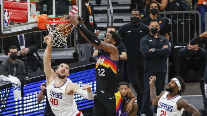 PHOENIX, ARIZONA - JUNE 22: Deandre Ayton #22 of the Phoenix Suns dunks the ball over Ivica Zubac #40 of the LA Clippers during the fourth quarter in game two of the NBA Western Conference finals in-which the Phoenix Suns defeated the LA Clippers 104-103 at Phoenix Suns Arena on June 22, 2021 in Phoenix, Arizona. NOTE TO USER: User expressly acknowledges and agrees that, by downloading and or using this photograph, User is consenting to the terms and conditions of the Getty Images License Agreement. (Photo by Christian Petersen/Getty Images)