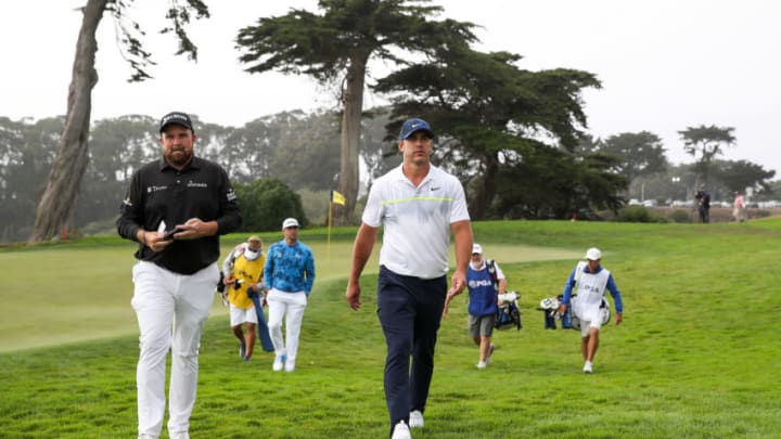 SAN FRANCISCO, CALIFORNIA - AUGUST 07: Shane Lowry of Ireland and Brooks Koepka of the United States walk off the 18th green during the second round of the 2020 PGA Championship at TPC Harding Park on August 07, 2020 in San Francisco, California. (Photo by Sean M. Haffey/Getty Images)