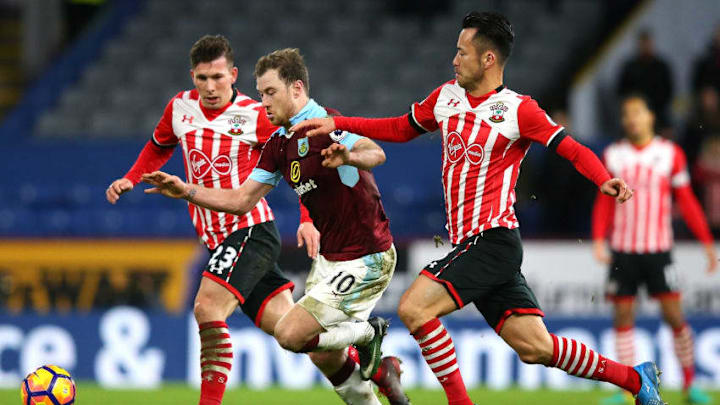 BURNLEY, ENGLAND - JANUARY 14: Ashley Barnes of Burnley (C) attempts to get away from Pierre-Emile Hojbjerg of Southampton (L) and Maya Yoshida of Southampton (R) during the Premier League match between Burnley and Southampton at Turf Moor on January 14, 2017 in Burnley, England. (Photo by Alex Livesey/Getty Images)
