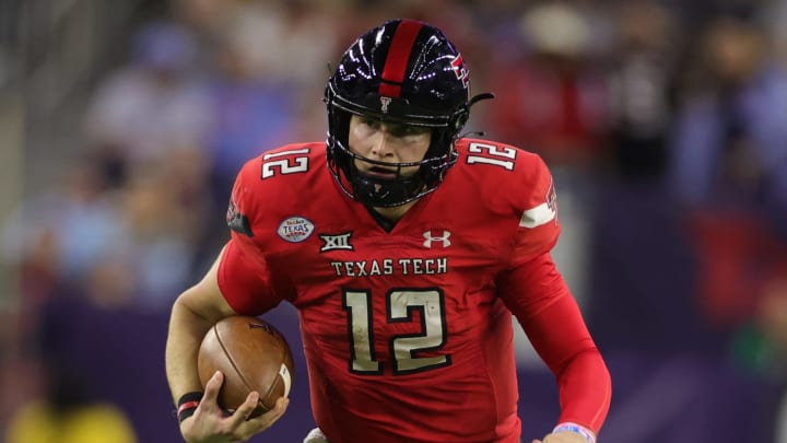 HOUSTON, TEXAS – DECEMBER 28: Tyler Shough #12 of the Texas Tech Red Raiders rushes with the ball against the Mississippi Rebels during the first half at NRG Stadium on December 28, 2022 in Houston, Texas. (Photo by Carmen Mandato/Getty Images)