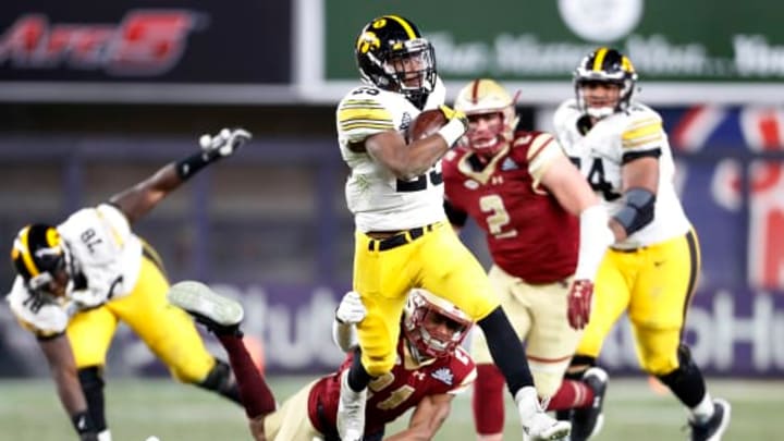 NEW YORK, NY – DECEMBER 27: Akrum Wadley #25 of the Iowa Hawkeyes breaks a tackle attempt by Lukas Denis #21 of the Boston College Eagles during the second half of the New Era Pinstripe Bowl at Yankee Stadium on December 27, 2017 in the Bronx borough of New York City. The Iowa Hawkeyes won 27-20. (Photo by Adam Hunger/Getty Images)