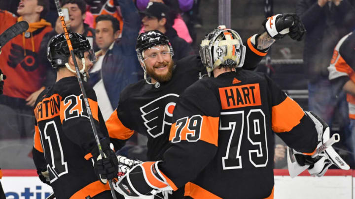 Feb 9, 2023; Philadelphia, Pennsylvania, USA; Philadelphia Flyers center Scott Laughton (21), left wing Nicolas Deslauriers (44) and goaltender Carter Hart (79) celebrate shootout win against the Edmonton Oilers at Wells Fargo Center. Mandatory Credit: Eric Hartline-USA TODAY Sports