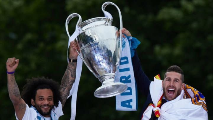 MADRID, SPAIN – MAY 27: Captain Sergio Ramos (R) of Real Madrid holds up the Champions League trophy with his teammate Marcelo (L)t as they celebrate at Cibeles Square a day after winning their 13th European Cup and UEFA Champions League Final on May 27, 2018 in Madrid, Spain. (Photo by Gonzalo Arroyo Moreno/Getty Images)