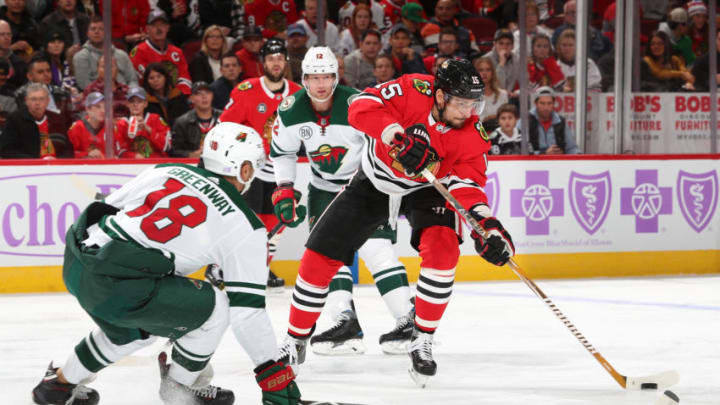 CHICAGO, IL - NOVEMBER 18: Artem Anisimov #15 of the Chicago Blackhawks looks to shoot against Jordan Greenway #18 of the Minnesota Wild in the second period at the United Center on November 18, 2018 in Chicago, Illinois. (Photo by Chase Agnello-Dean/NHLI via Getty Images)