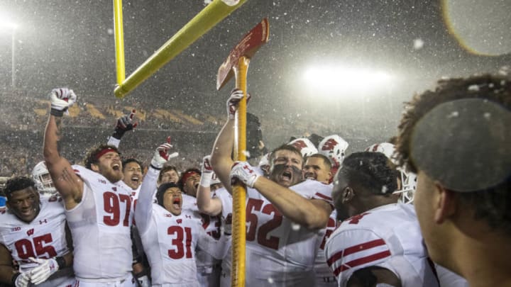 Nov 30, 2019; Minneapolis, MN, USA; Wisconsin Badgers defensive end David Pfaff (52) holds up the Paul Bunyan Axe Trophy after defeating the Minnesota Golden Gophers at TCF Bank Stadium. Mandatory Credit: Jesse Johnson-USA TODAY Sports