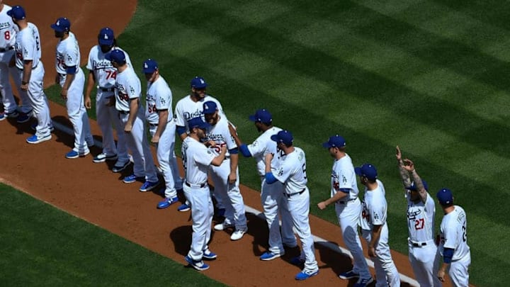 LOS ANGELES, CA - MARCH 28: Pitcher Clayton Kershaw #22 of the Los Angeles Dodgers is greeted by his teammates as they line up for an Opening Day game against Arizona Diamondbacks at Dodger Stadium on March 28, 2019 in Los Angeles, California. (Photo by Kevork Djansezian/Getty Images)
