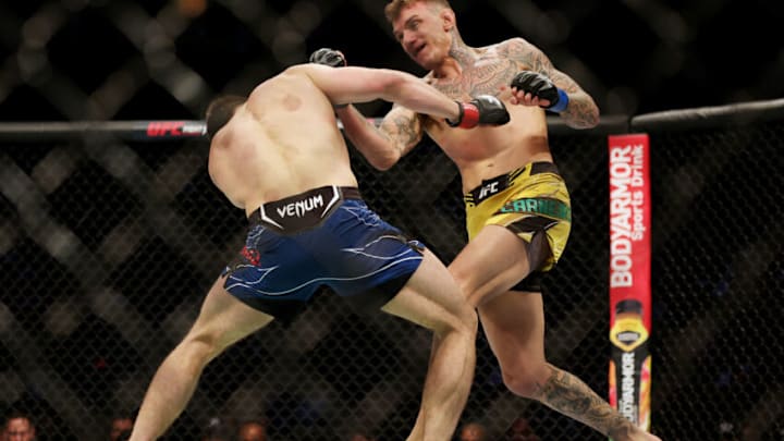 HOUSTON, TEXAS - FEBRUARY 12: Renato Moicano of Brazil punches Alexander Hernandez in their lightweight fight during UFC 271 at Toyota Center on February 12, 2022 in Houston, Texas. (Photo by Carmen Mandato/Getty Images)