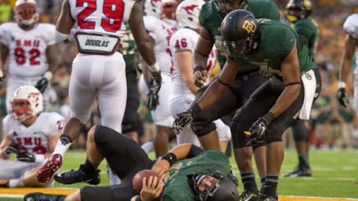 Aug 31, 2014; Waco, TX, USA; Baylor Bears quarterback Bryce Petty (14) appears to be injured as he scores a touchdown against the Southern Methodist Mustangs during the first half at McLane Stadium. Mandatory Credit: Jerome Miron-USA TODAY Sports