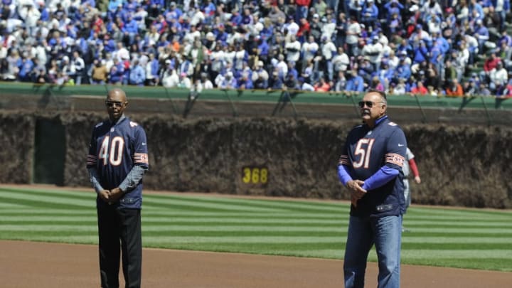 CHICAGO, IL - APRIL 23: Gayle Sayers #40 and Dick Butkus #51 during pre game festivities on the birthday of the ballpark on April 23, 2014 at Wrigley Field in Chicago, Illinois. Today marks the 100th anniversary of the first game ever played in the historic venue. (Photo by David Banks/Getty Images)