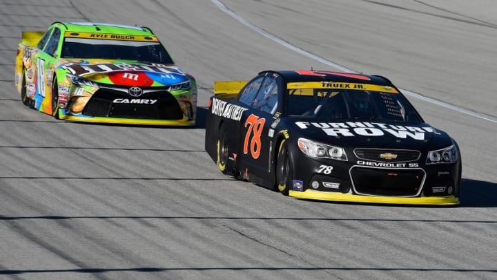Sep 20, 2015; Joliet, IL, USA; NASCAR Sprint Cup Series driver Martin Truex Jr. (78) leads NASCAR Sprint Cup Series driver Kyle Busch (18) during the MyAfibRisk.com 400 at Chicagoland Speedway. Mandatory Credit: Jasen Vinlove-USA TODAY Sports