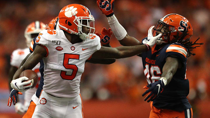 SYRACUSE, NEW YORK – SEPTEMBER 14: Tee Higgins #5 of the Clemson Tigers grabs Lakiem Williams #46 of the Syracuse Orange’s face mask during a game at the Carrier Dome on September 14, 2019 in Syracuse, New York. (Photo by Bryan M. Bennett/Getty Images)