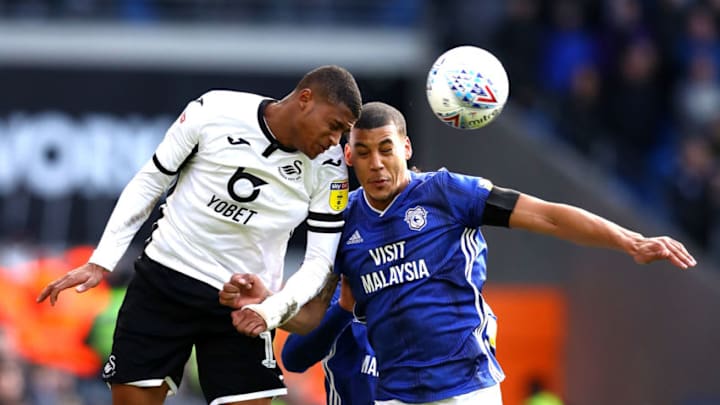 CARDIFF, WALES - JANUARY 12: Lee Peltier of Cardiff City and Rhian Brewster of Swansea City battle for possession during the Sky Bet Championship match between Cardiff City and Swansea City at Cardiff City Stadium on January 12, 2020 in Cardiff, Wales. (Photo by Michael Steele/Getty Images)