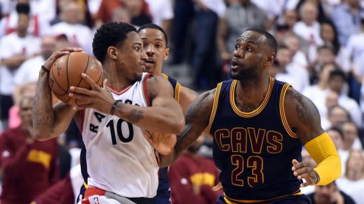 May 23, 2016; Toronto, Ontario, CAN; Toronto Raptors guard DeMar DeRozan (10) holds the ball away from Cleveland Cavaliers forward LeBron James (23) in game four of the Eastern conference finals of the NBA Playoffs at Air Canada Centre. The Raptors won 105-99. Mandatory Credit: Dan Hamilton-USA TODAY Sports