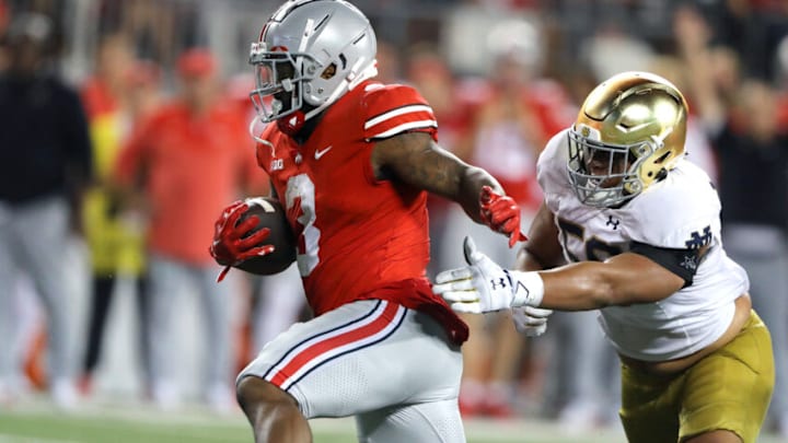 Sep 3, 2022; Columbus, Ohio, USA; Ohio State Buckeyes running back Miyan Williams (3) runs for the first down past Notre Dame Fighting Irish defensive lineman Jayson Ademilola (57) during the fourth quarter at Ohio Stadium. Mandatory Credit: Joseph Maiorana-USA TODAY Sports Sep 3, 2022; Columbus, Ohio, USA; Ohio State Buckeyes running back Miyan Williams (3) runs for the first down past Notre Dame Fighting Irish defensive lineman Jayson Ademilola (57) during the fourth quarter at Ohio Stadium. Mandatory Credit: Joseph Maiorana-USA TODAY Sports