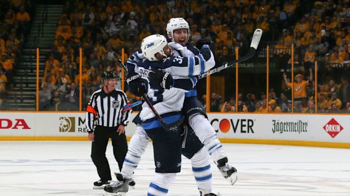 NASHVILLE, TN - MAY 05: Brandon Tanev #13 of the Winnipeg Jets jumps into the arms of teammate Dustin Byfuglien #33 to congratulate him on scoring a goal against the Nashville Predators during the second period of Game Five of the Western Conference Second Round during the 2018 NHL Stanley Cup Playoffs at Bridgestone Arena on May 5, 2018 in Nashville, Tennessee. (Photo by Frederick Breedon/Getty Images)