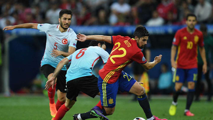 NICE, FRANCE - JUNE 17: Selcuk Inan of Turkey attempts to tackle Nolito of Spain during the UEFA EURO 2016 Group D match between Spain and Turkey at Allianz Riviera Stadium on June 17, 2016 in Nice, France. (Photo by David Ramos/Getty Images)