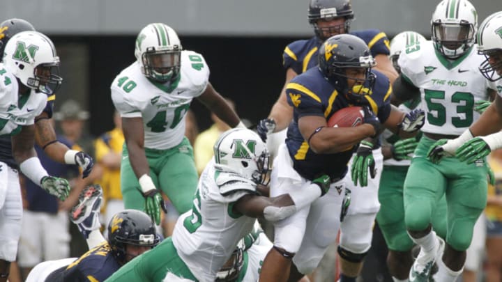 MORGANTOWN, WV - SEPTEMBER 01: Shawne Alston #20 of the West Virginia Mountaineers carries the ball against the Marshall Thundering Herd during the game on September 1, 2012 at Mountaineer Field in Morgantown, West Virginia. (Photo by Justin K. Aller/Getty Images)