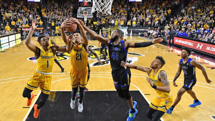 WICHITA, KS - MARCH 08: Jaime Echenique #21 of the Wichita State Shockers grabs a defensive rebound against Jeriah Horne #41 of the Tulsa Golden Hurricane during the first half at Charles Koch Arena on March 8, 2020 in Wichita, Kansas. (Photo by Peter G. Aiken/Getty Images)