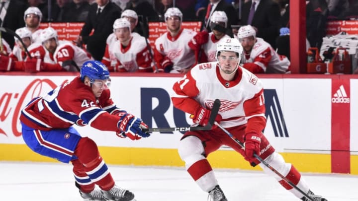MONTREAL, QC - MARCH 26: Dylan Larkin #71 of the Detroit Red Wings skates the puck against Byron Froese during the NHL game at the Bell Centre on March 26, 2018 in Montreal, Quebec, Canada. (Photo by Minas Panagiotakis/Getty Images)