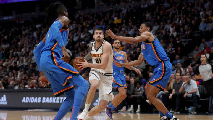 Juancho Hernangomez #41 of the Denver Nuggets drives against Nerlens Noel #9 and Darius Bazley #7 of the OKC Thunder (Photo by Matthew Stockman/Getty Images)