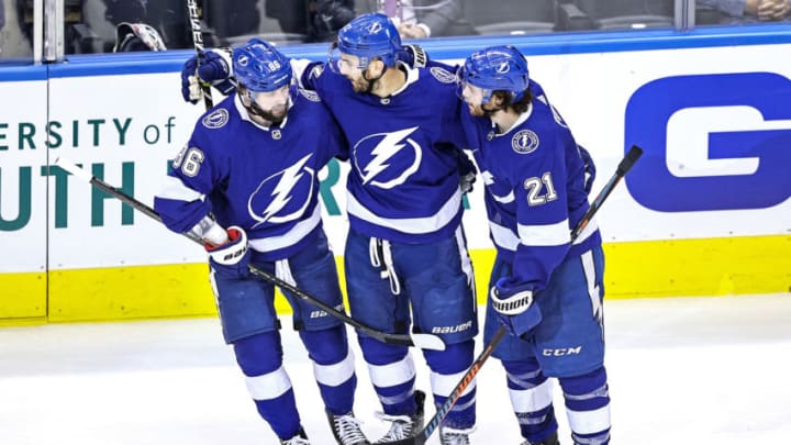 TORONTO, ONTARIO - AUGUST 19: Kevin Shattenkirk #22 of the Tampa Bay Lightning is congratulated by his teammates, Nikita Kucherov #86 and Brayden Point #21 after scoring a goal against the Columbus Blue Jackets at 12:01 during the third period in Game Five of the Eastern Conference First Round during the 2020 NHL Stanley Cup Playoffs at Scotiabank Arena on August 19, 2020 in Toronto, Ontario. (Photo by Elsa/Getty Images)