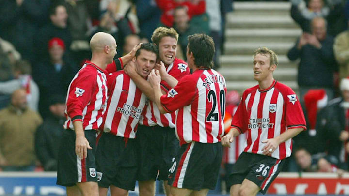 SOUTHAMPTON, ENGLAND – DECEMBER 21: The Southampton players congratulate team mate Jason Dodd after scoring the opening goal during the FA Barclaycard Premiership match between Southampton and Portsmouth at St Mary’s Stadium on December 21, 2003 in Southampton, England. (Photo by Mike Hewitt/Getty Images)