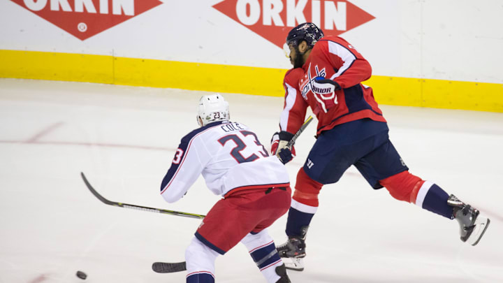 WASHINGTON, DC – APRIL 21: Washington Capitals right wing Devante Smith-Pelly (25) shoots past Columbus Blue Jackets defenseman Ian Cole (23) during the first round Stanley Cup playoff game 5 between the Washington Capitals and the Columbus Blue Jackets on April 21, 2018, at Capital One Arena, in Washington, D.C. The Capitals defeated the Blue Jackets 4-3 in overtime.(Photo by Tony Quinn/Icon Sportswire via Getty Images)