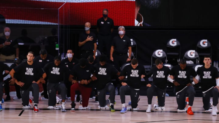 Players take a knee during the national anthem before the start of a game between the Miami Heat and the Oklahoma City Thunder (Photo by Kevin C. Cox/Getty Images)