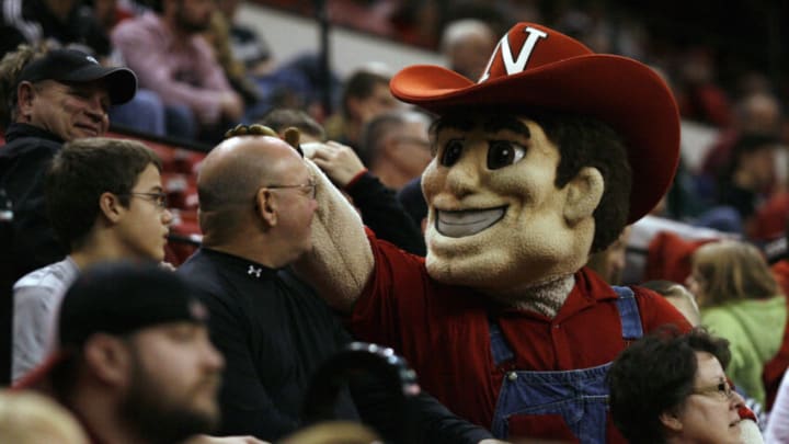 Nebraska football mascot Herbie Husker rubs the head of a fan (Bruce Thorson-USA TODAY Sports)