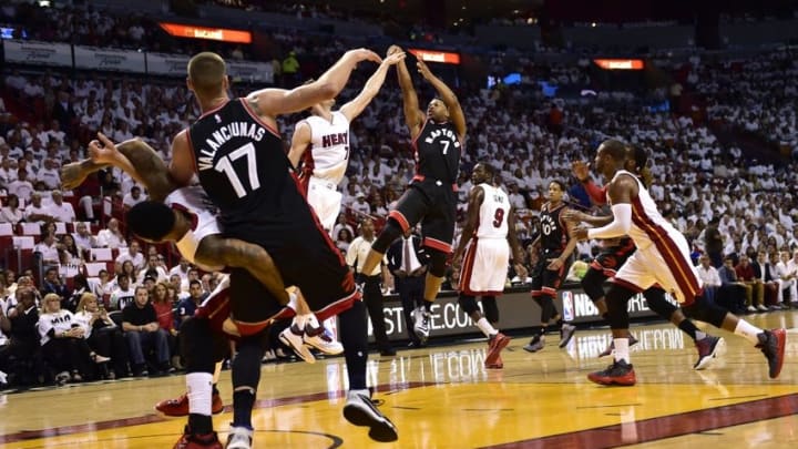May 7, 2016; Miami, FL, USA; Toronto Raptors guard Kyle Lowry (7) shoots over Miami Heat guard Goran Dragic (7) during the first quarter in game three of the second round of the NBA Playoffs at American Airlines Arena. Mandatory Credit: Steve Mitchell-USA TODAY Sports